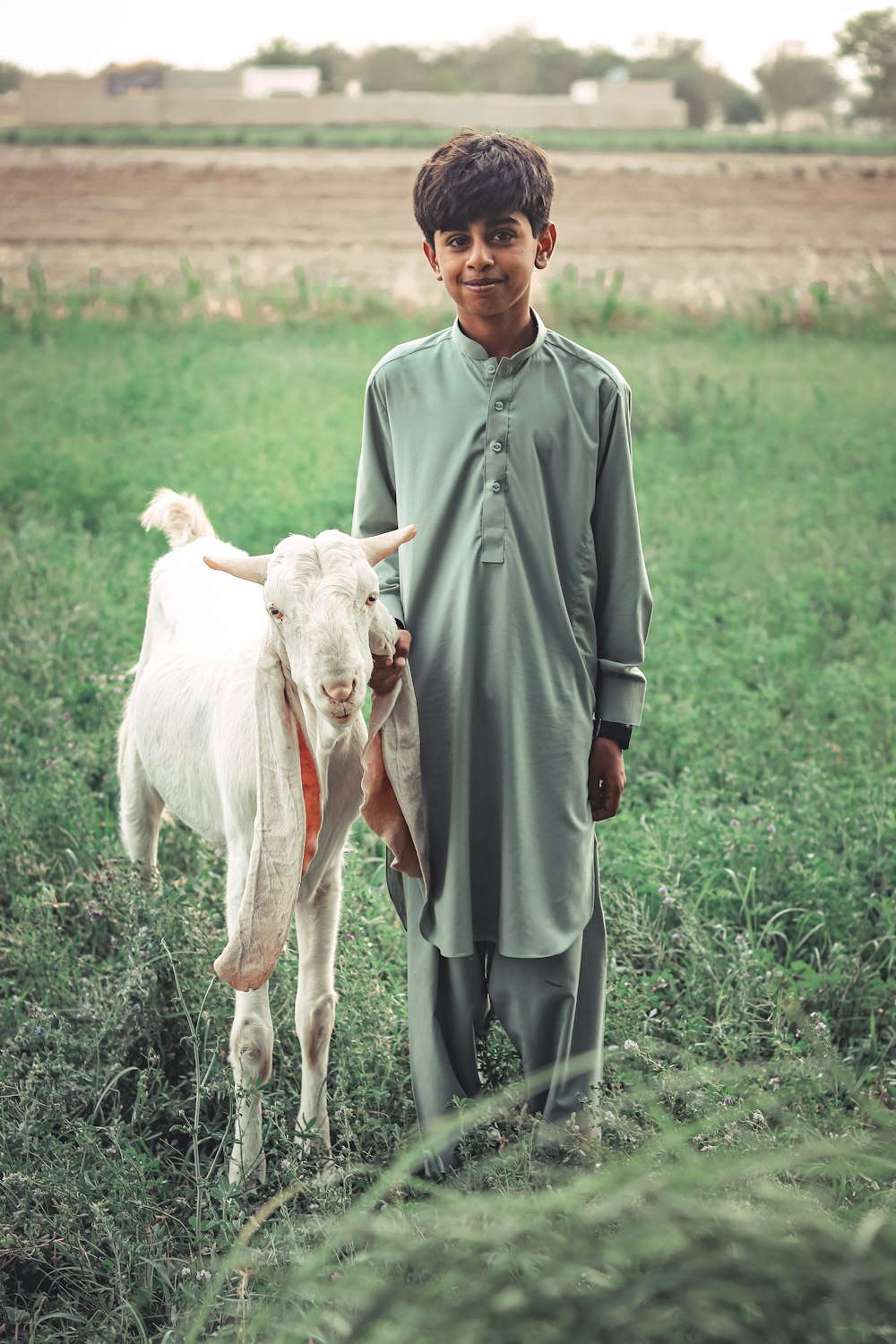 a man holding a goat