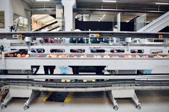 Industrial fruit pulp production line with fresh fruits and hygienic packaging in a clean factory environment.