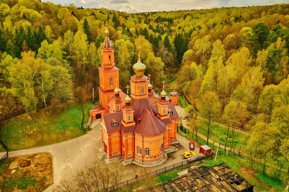 a large red building with a dome and a road in front of it