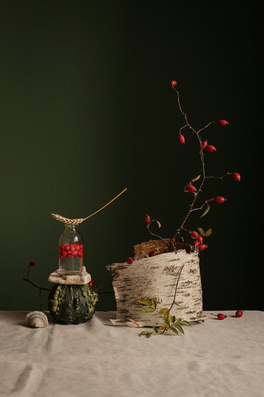a small tree with a candle and a small tree with red berries
