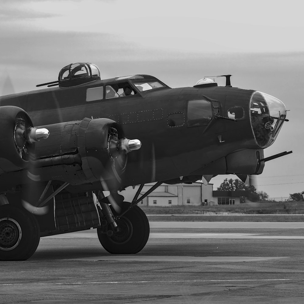 a black and white photo of a plane on a runway