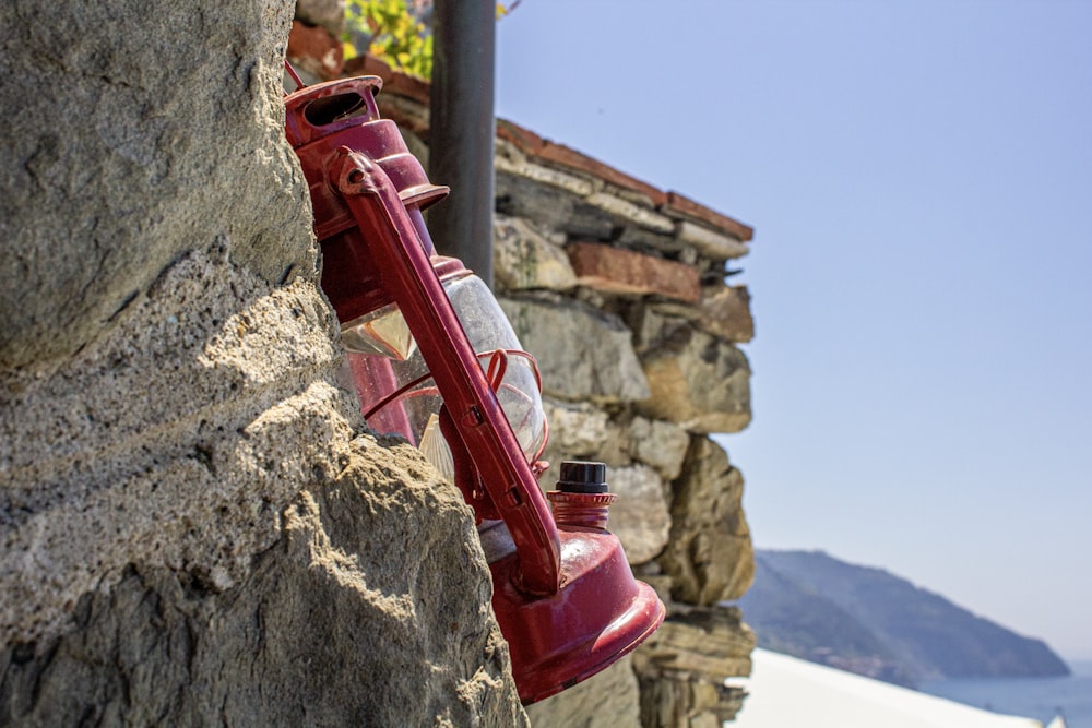 a red pipe on a rock