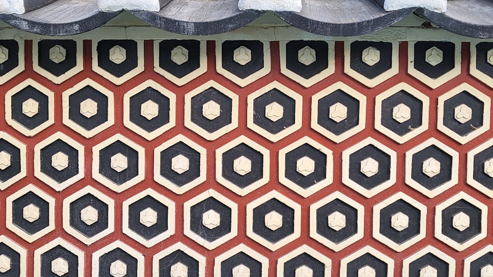 a red and black patterned pillow