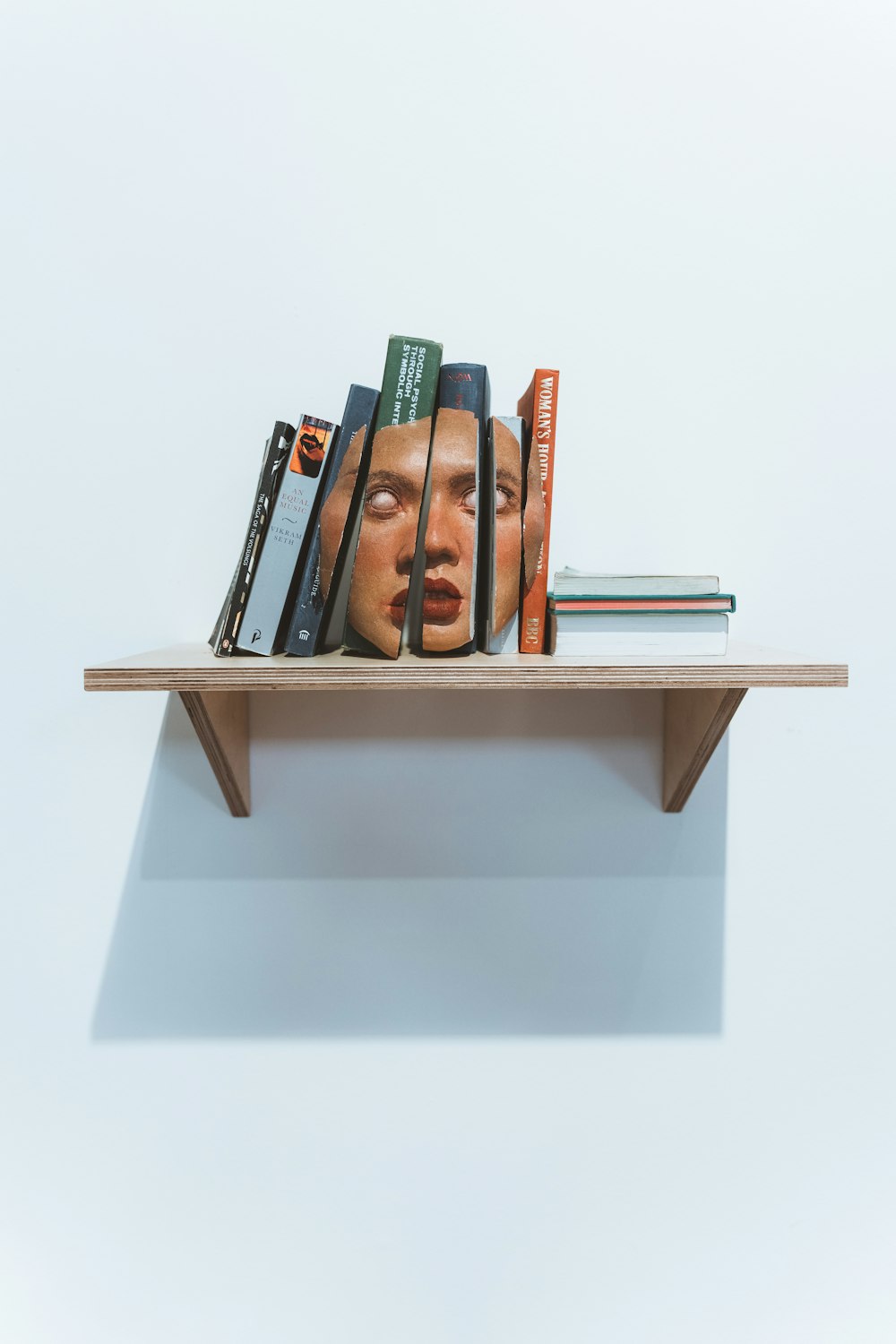 a shelf with books and pens on it