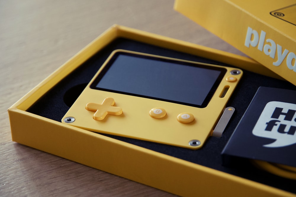 a yellow handheld gaming device