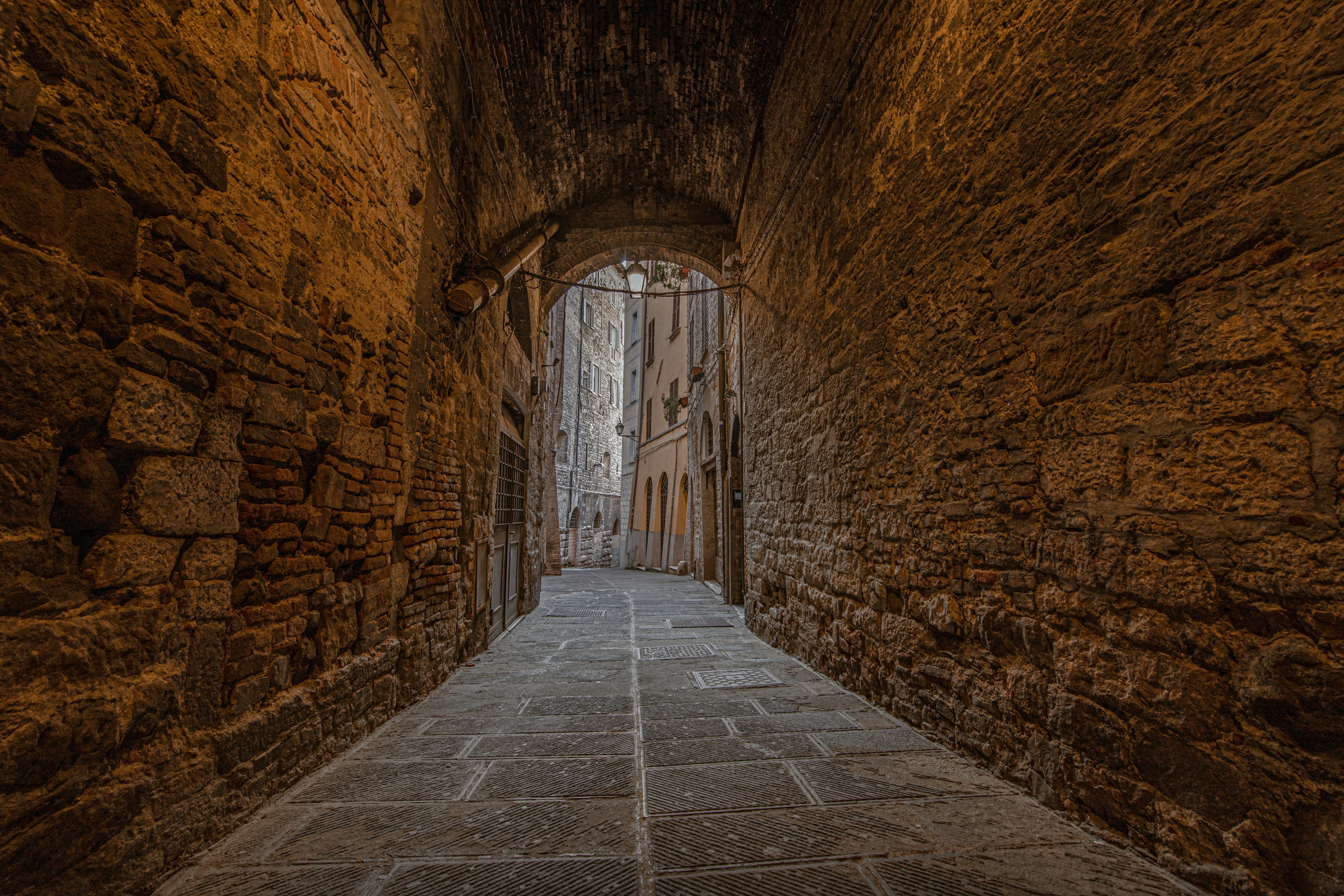 a stone walkway in a stone tunnel, HDR of 5 photo of street in Perugia, Umbria, Italy.</p><p>