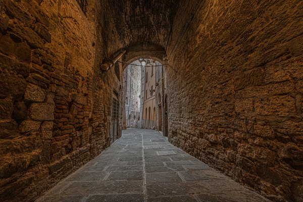 A stone walkway in a stone tunnel — Perugia, Italy
