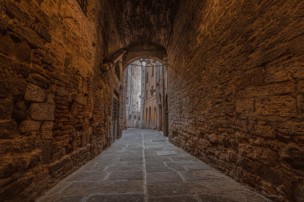 a stone walkway in a stone tunnel