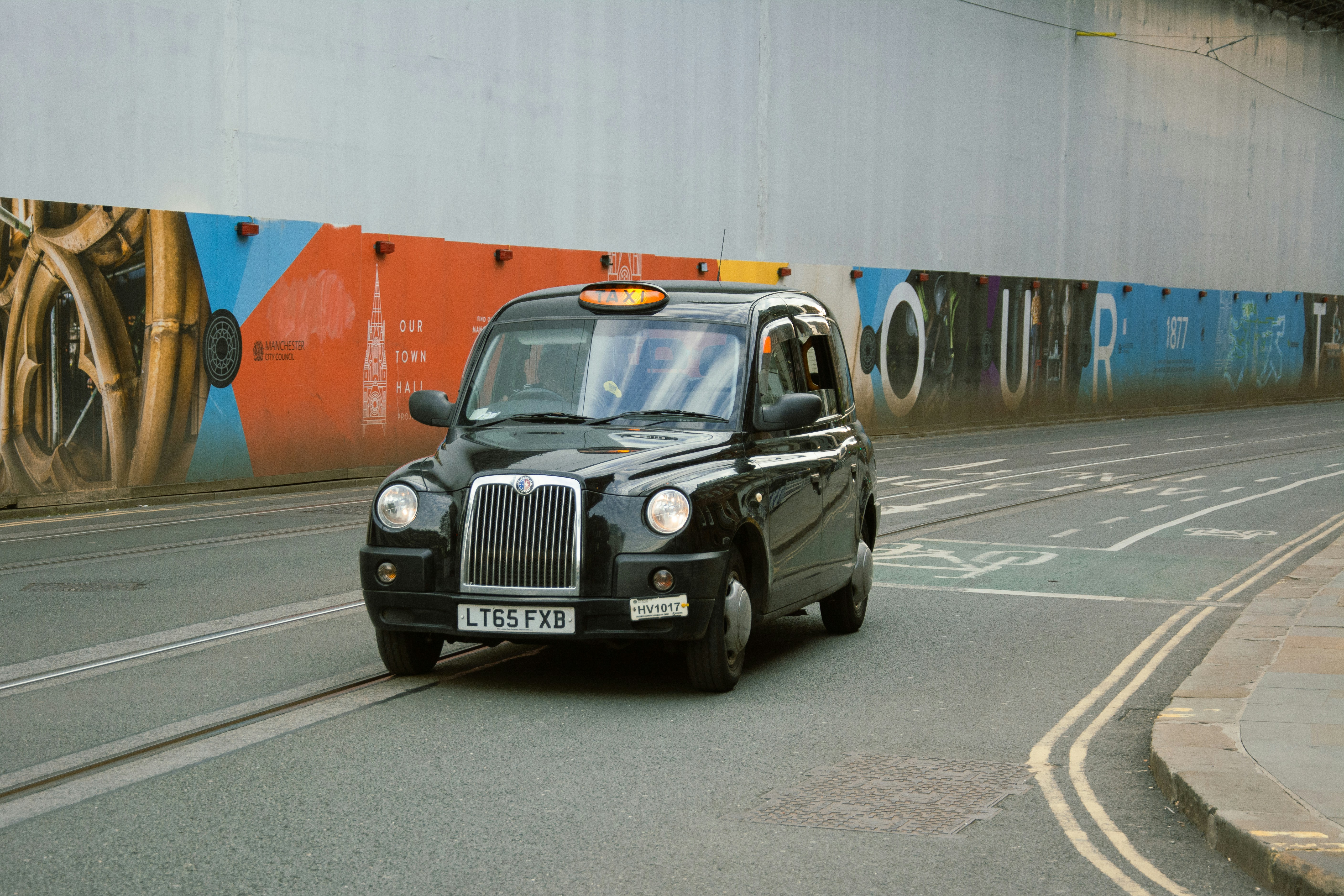 a black car on a road manchester airport