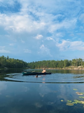 a couple people in a boat on a lake