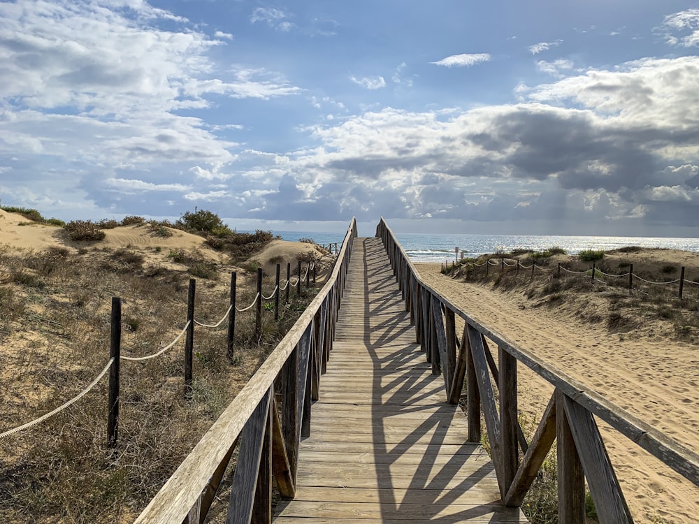 a wooden bridge over a beach