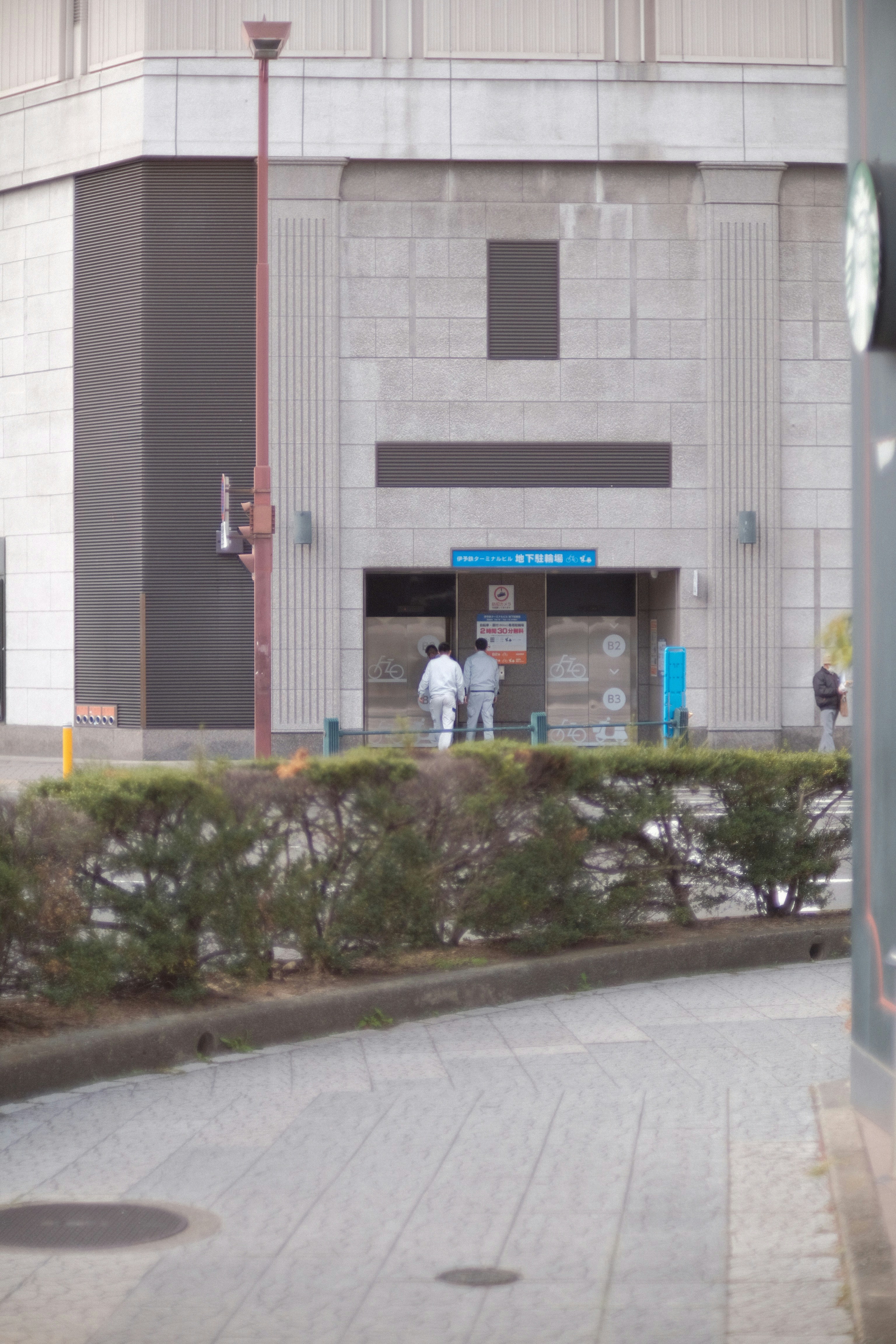 a group of people walking out of a building