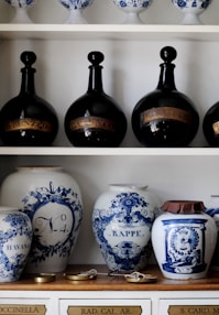 a shelf with vases and pots