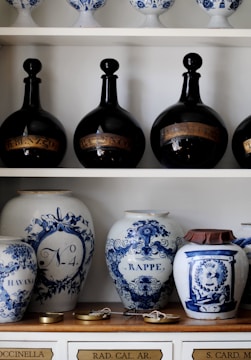 a shelf with vases and pots