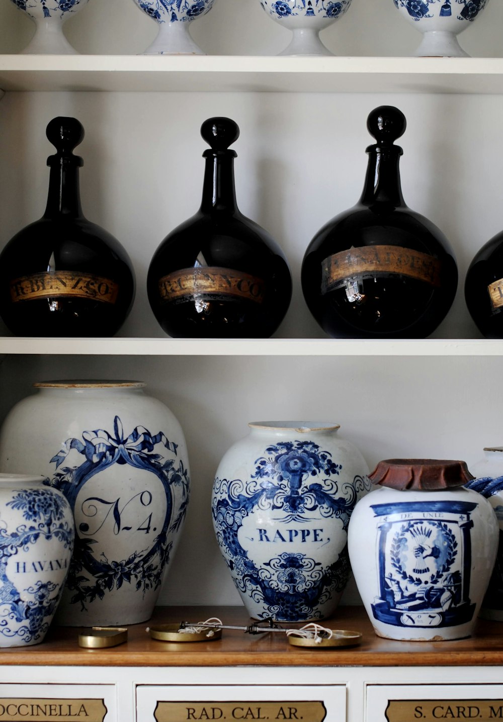 a shelf with vases and pots