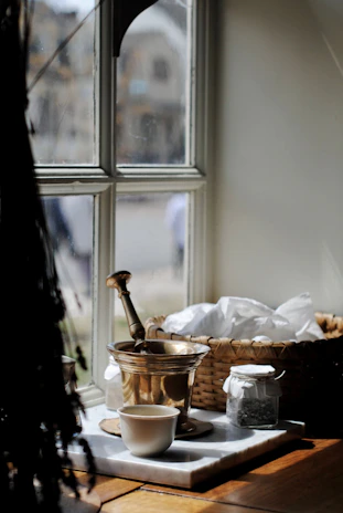 A cozy kitchen scene with fresh spices and a mortar and pestle ready for grinding.