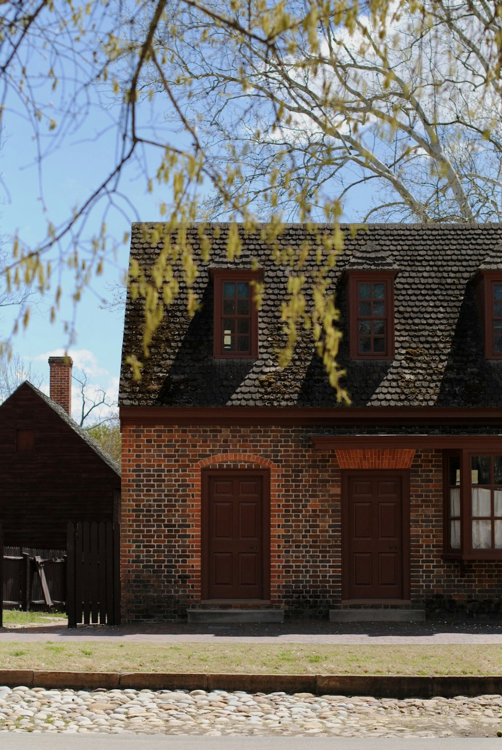 a brick building with a tree in the front