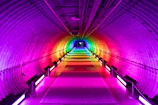An elegant infinity tunnel with mirrors and colorful lighting creating a stunning visual effect.