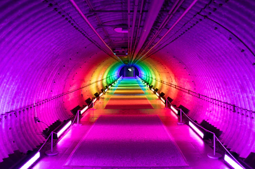 An elegant infinity tunnel with mirrors and colorful lighting creating a stunning visual effect.
