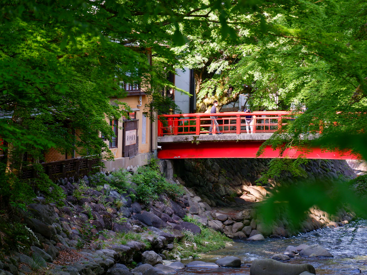 The red Katsura Bridge over the river in Shuzenji onsen town