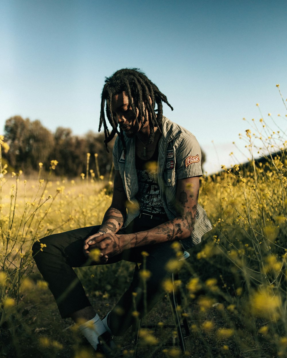 a man sitting in a field