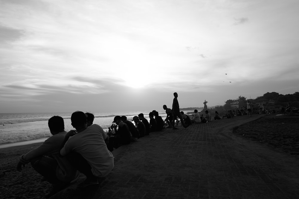 a group of people sitting on a beach