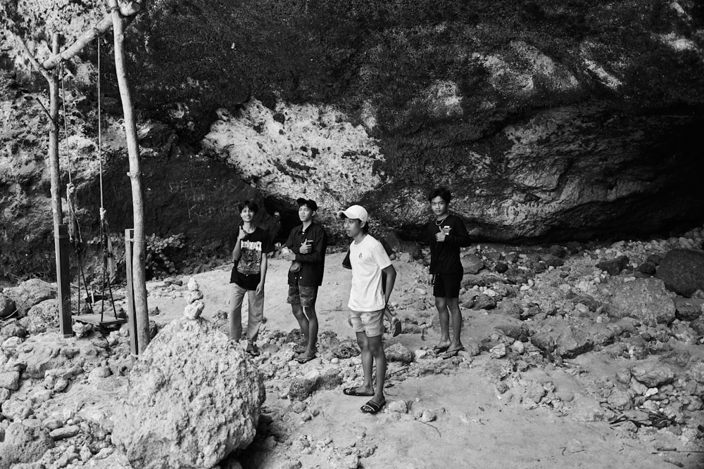 a group of people standing on a rocky path