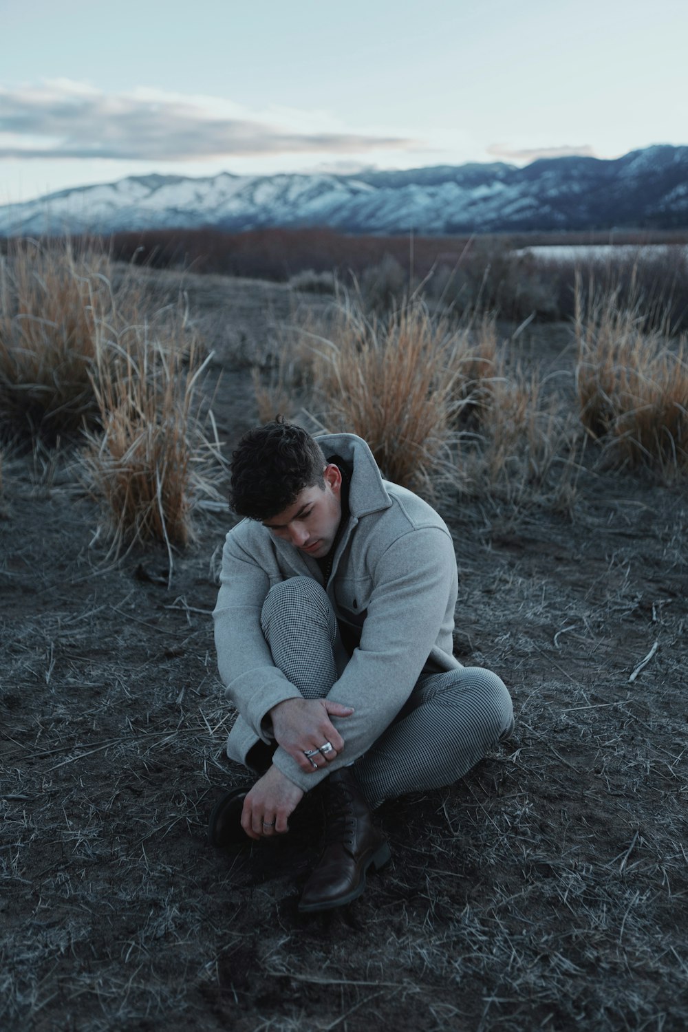 a person kneeling in a field