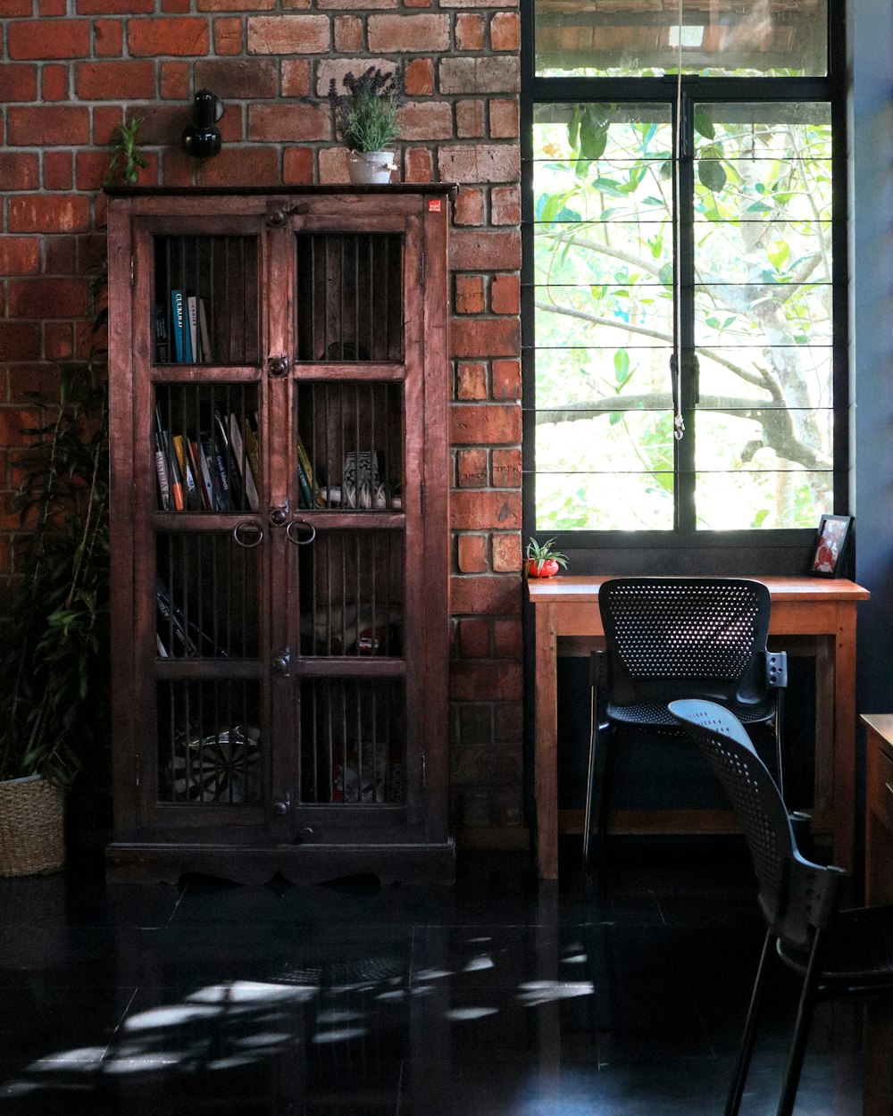 a wood cabinet with a chair and a table in front of it