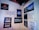 A wall displays various motivational and humorous quotes on individual posters. The messages range from thoughts on travel, marriage, and cooking, to humorous takes on food and personal growth. Some quotes include references to adventure, honest living, and achieving challenging goals.