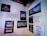 A wall displays various motivational and humorous quotes on individual posters. The messages range from thoughts on travel, marriage, and cooking, to humorous takes on food and personal growth. Some quotes include references to adventure, honest living, and achieving challenging goals.