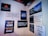 A wall displays various motivational and humorous quotes on individual posters. The messages range from thoughts on travel, marriage, and cooking, to humorous takes on food and personal growth. Some quotes include references to adventure, honest living, and achieving challenging goals.