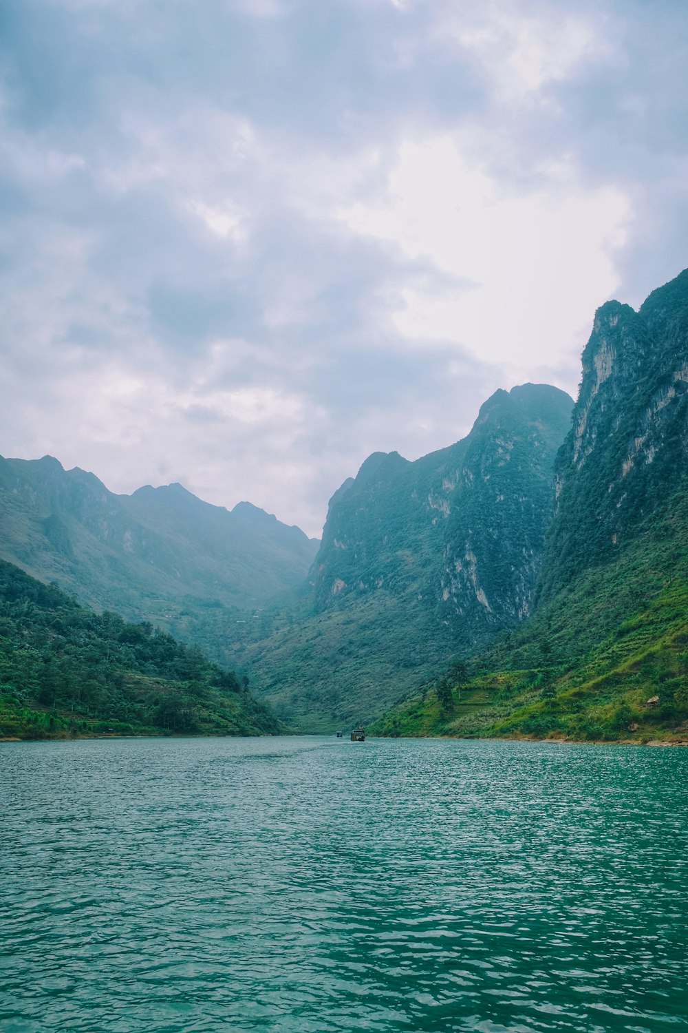 a body of water with mountains in the back