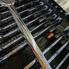 A close-up of bicycle tools neatly arranged on a workbench.