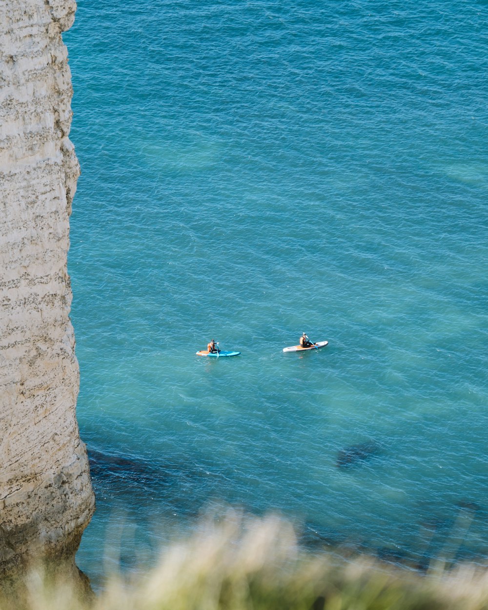 a group of people in kayaks on a body of water