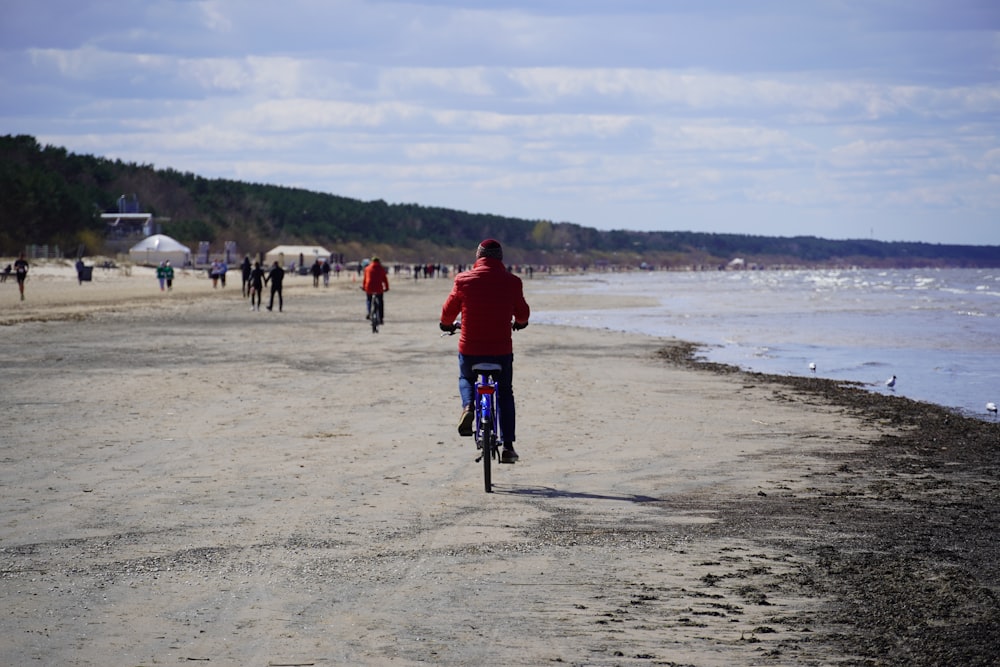 a person riding a bicycle on a beach