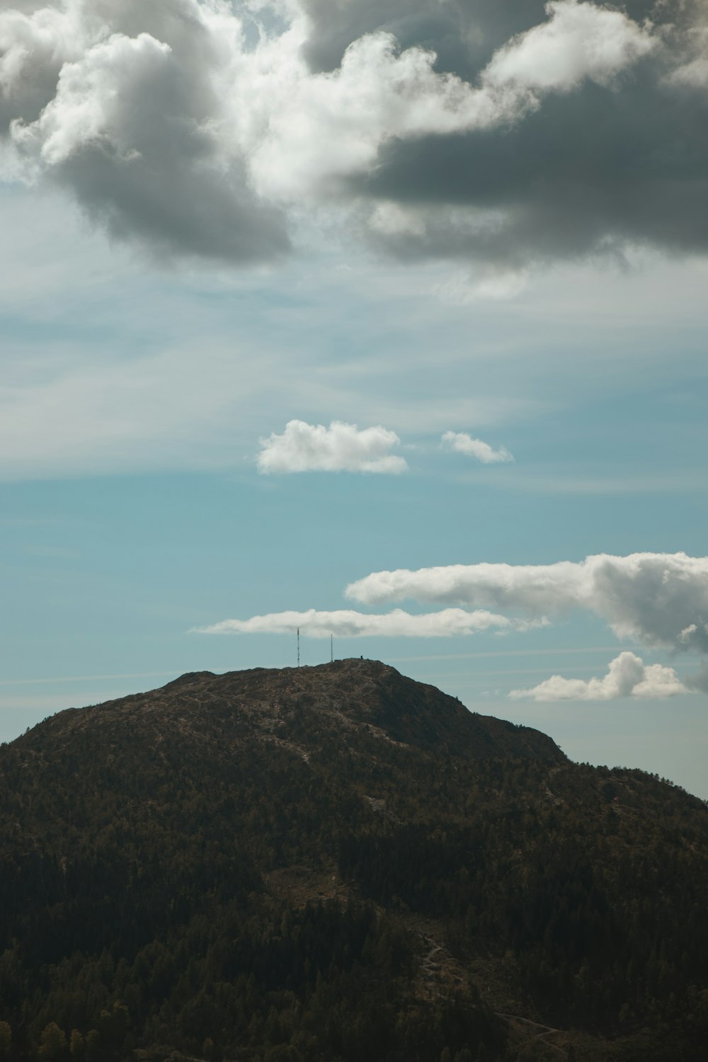 a mountain with clouds above it