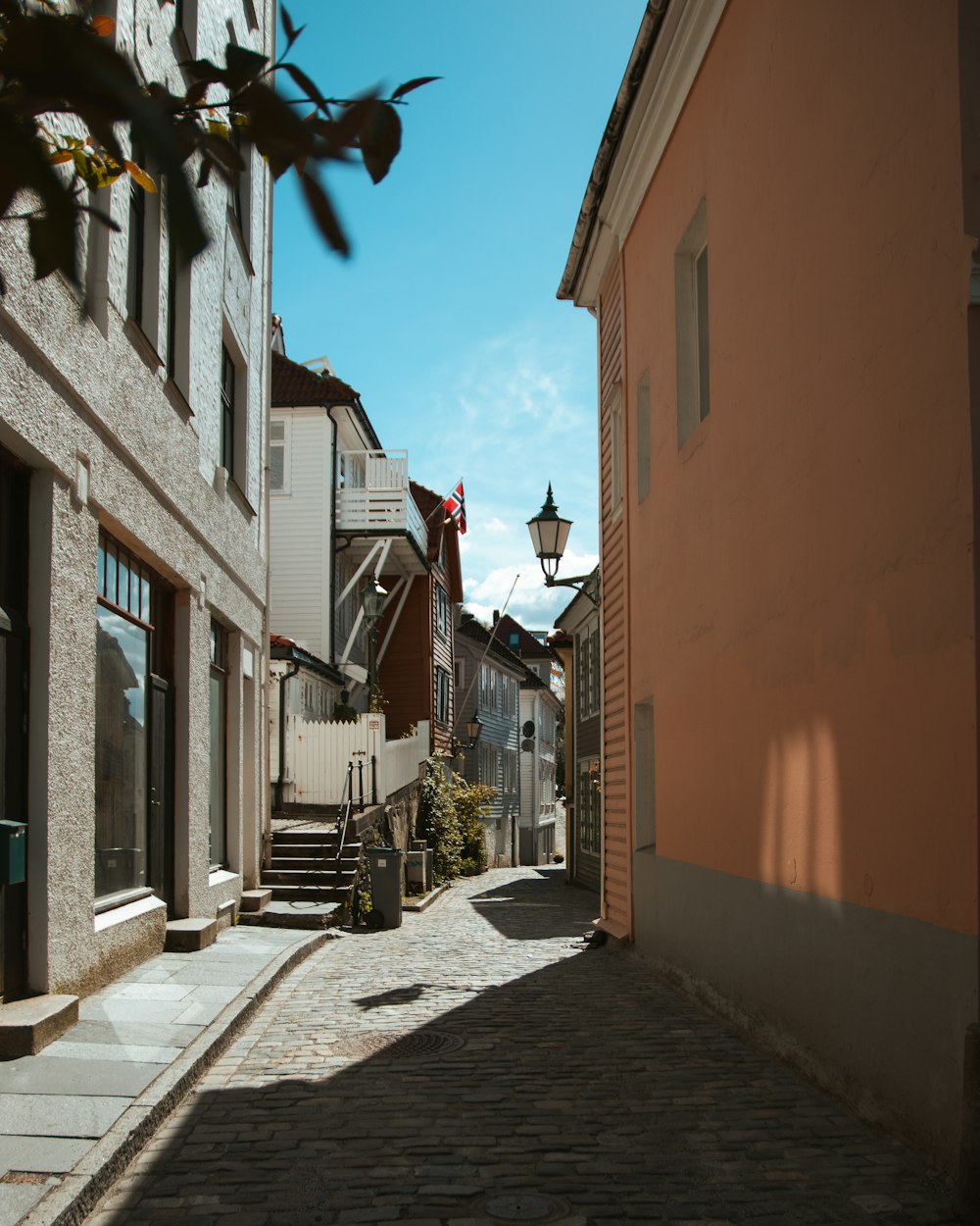 a cobblestone street between buildings