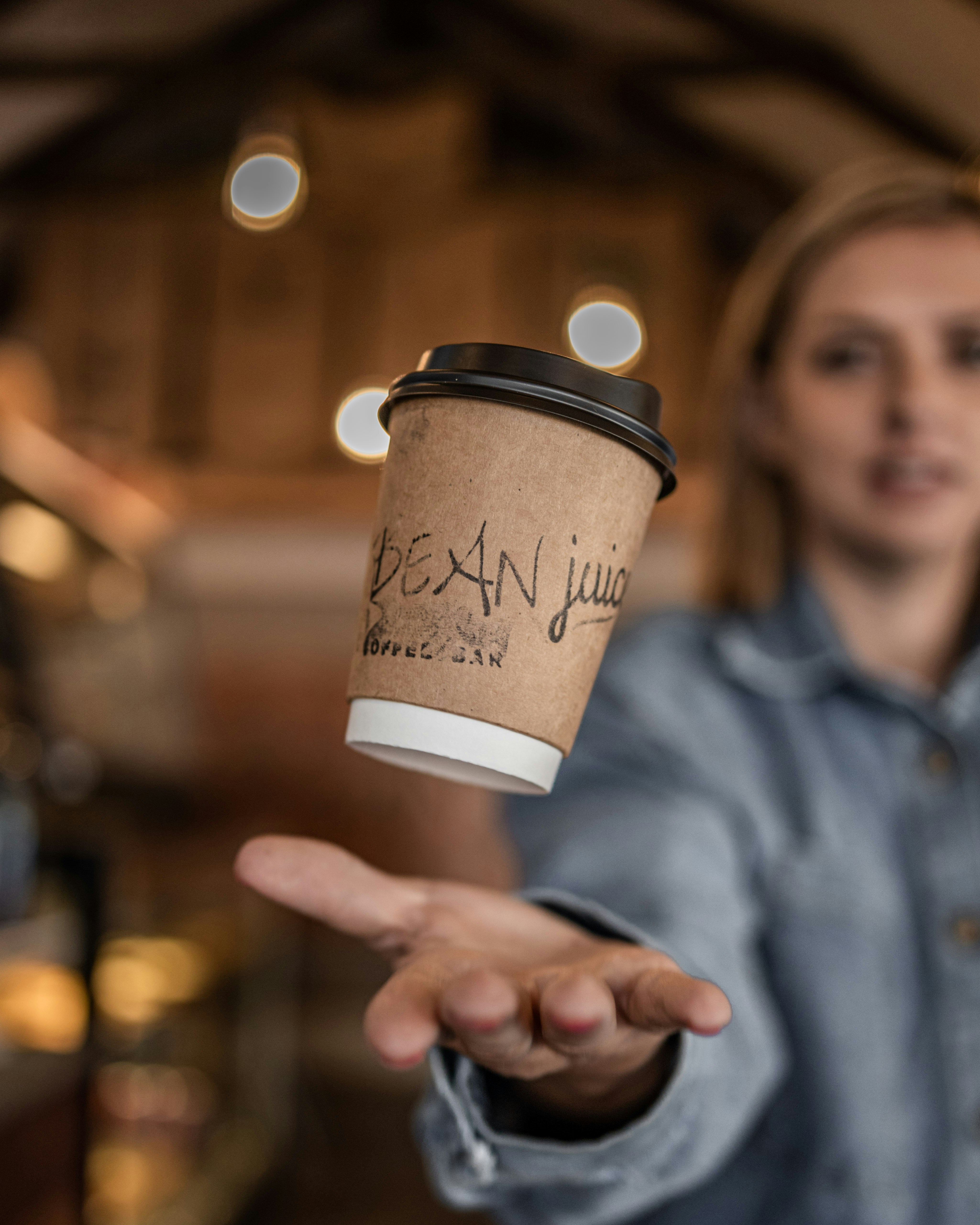 a person holding a coffee cup