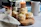 A jar of vanilla essence next to freshly baked cookies on a rustic wooden table