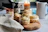 A jar of vanilla essence next to freshly baked cookies on a rustic wooden table