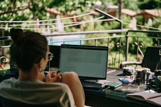 a person sitting at a desk with a laptop
