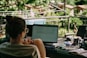 a person sitting at a desk with a laptop