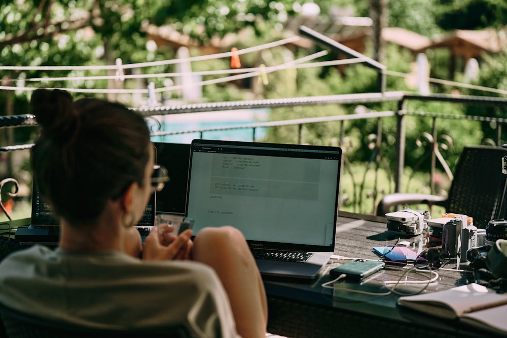 a person sitting at a desk with a laptop