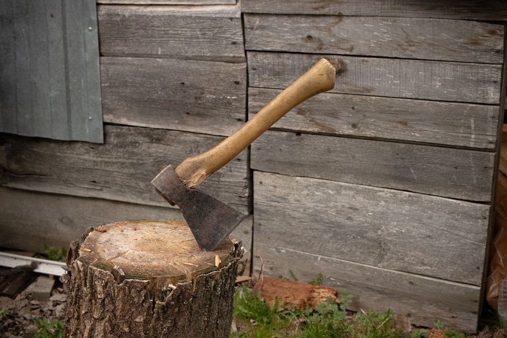 a hammer and a nail on a wooden surface