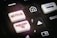 A close-up of a remote control featuring buttons for various streaming services, including Netflix and Rakuten TV, along with other navigational buttons.