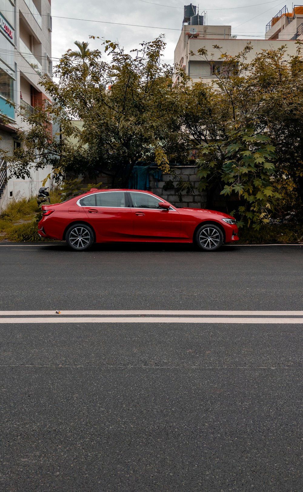 a red car parked on the side of a road