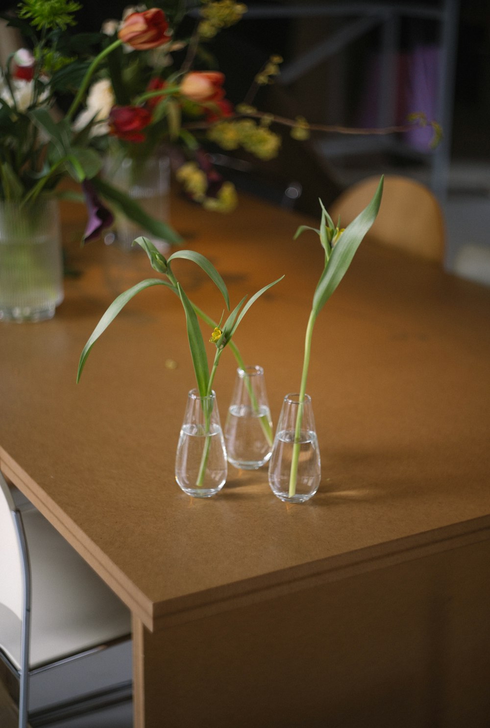 a group of glass vases with flowers in them