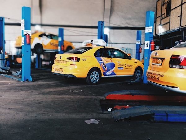 a couple of cars parked next to each otherby Ilya Chunin