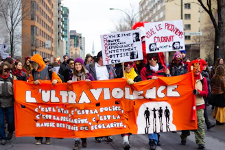 A diverse group of people walking together peacefully through Place de la République in Paris.
